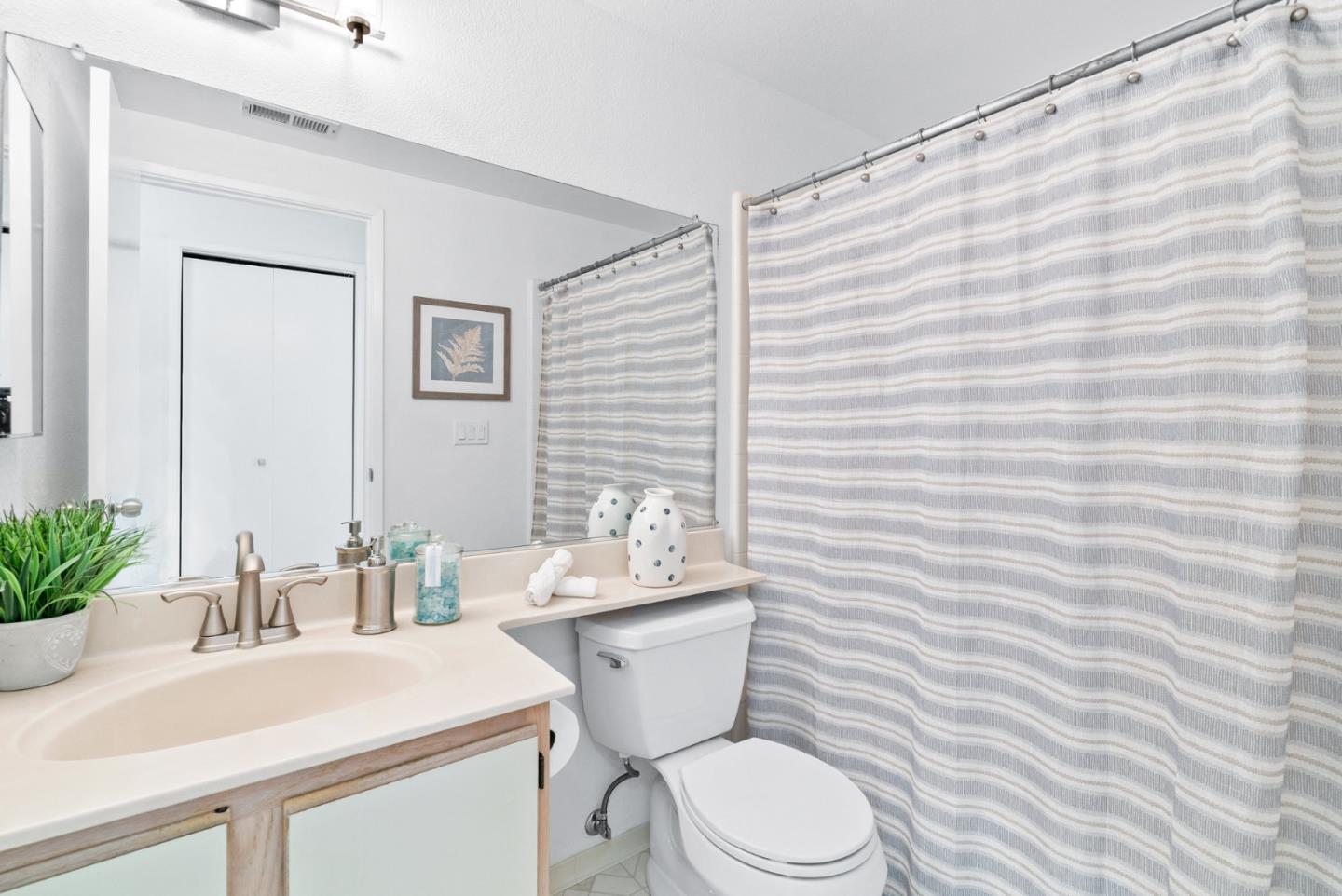 2615 Willowbrook Lane, Unit 82 Aptos, CA 95003 - Photo 19 of 27 a bathroom with a sink a toilet and mirror