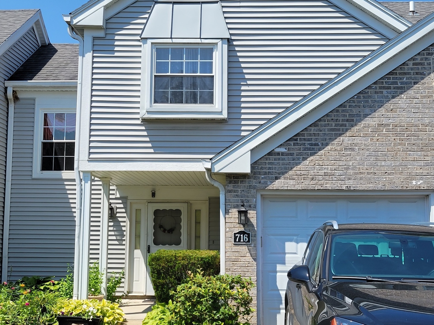 716 Sutton Circle Wheeling, IL 60090 - Photo 1 of 38 a front view of a house with garden