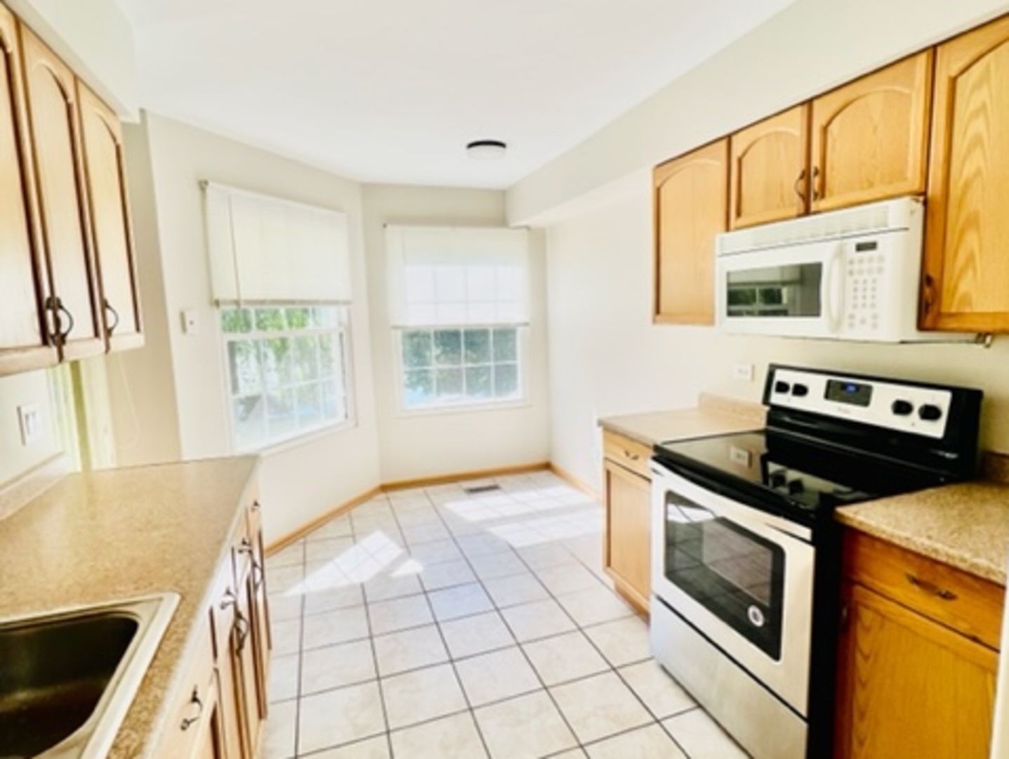 716 Sutton Circle Wheeling, IL 60090 - Photo 13 of 38 a kitchen with a stove a sink and a microwave