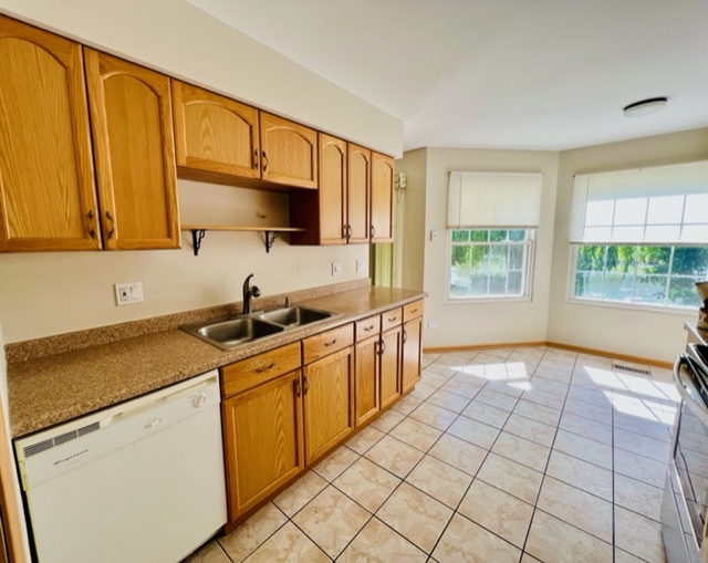 716 Sutton Circle Wheeling, IL 60090 - Photo 17 of 38 a kitchen with stainless steel appliances a sink stove and cabinets