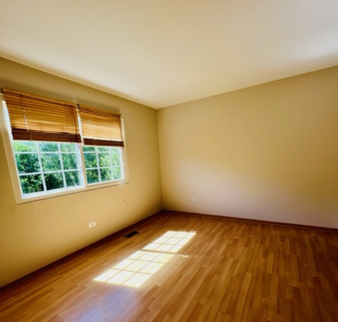 716 Sutton Circle Wheeling, IL 60090 - Photo 30 of 38 a view of an empty room with wooden floor and a window