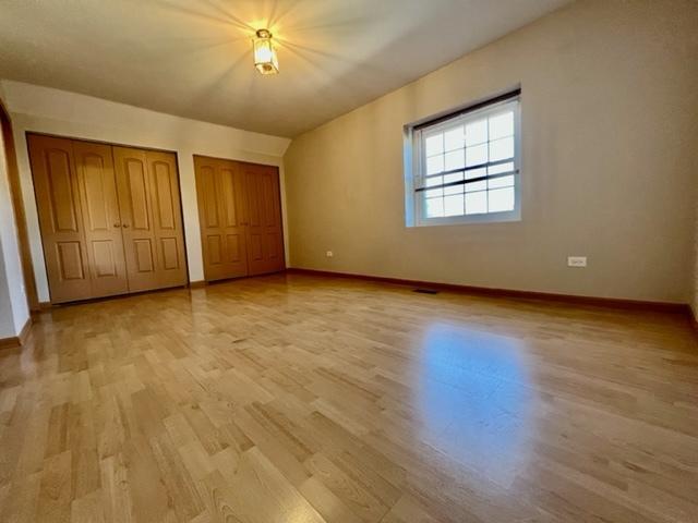 716 Sutton Circle Wheeling, IL 60090 - Photo 35 of 38 a view of an empty room with wooden floor and a window