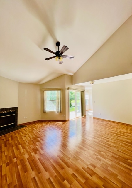 716 Sutton Circle Wheeling, IL 60090 - Photo 9 of 38 a view of an empty room with wooden floor and a window