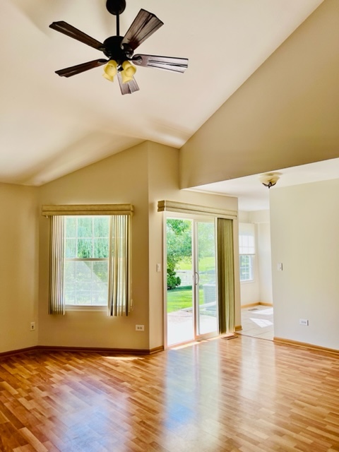 716 Sutton Circle Wheeling, IL 60090 - Photo 10 of 38 a view of an empty room with a window and wooden floor