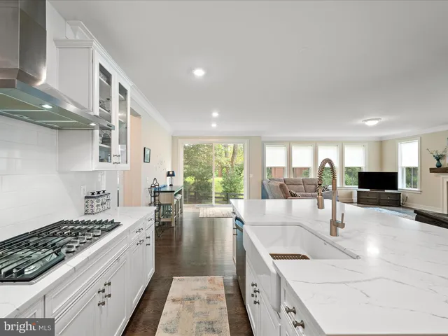 a kitchen with granite countertop a stove and a sink