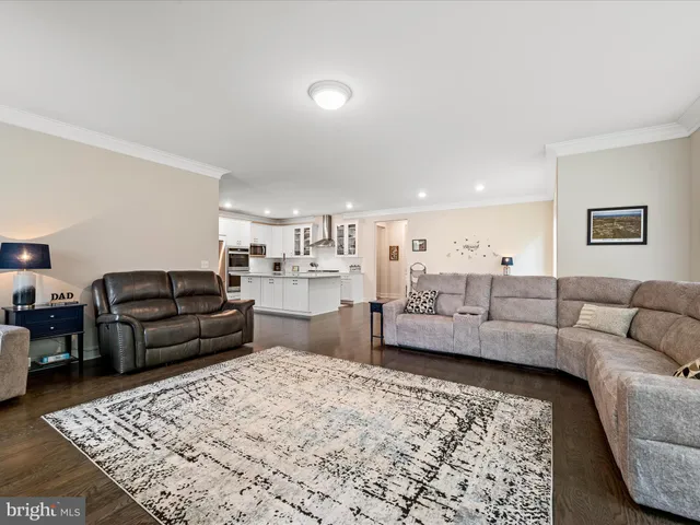 a living room with furniture wooden floor and a flat screen tv