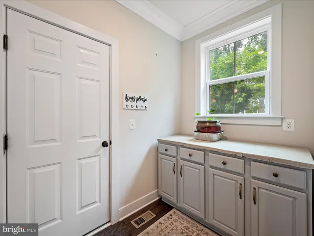 a view of living room filled with furniture and a chandelier