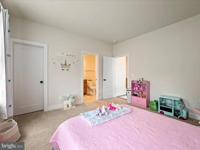 a spacious bedroom with two beds and a large window