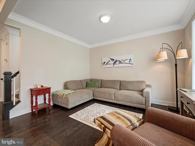 a living room with furniture a couch and a flat screen tv