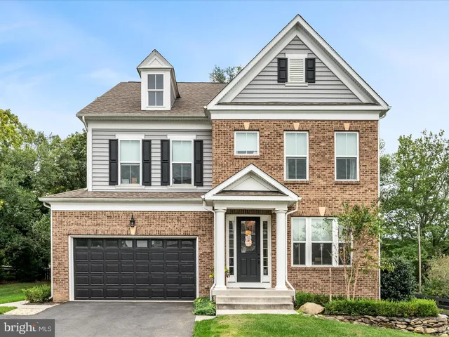 an aerial view of a house with a garden and lake view