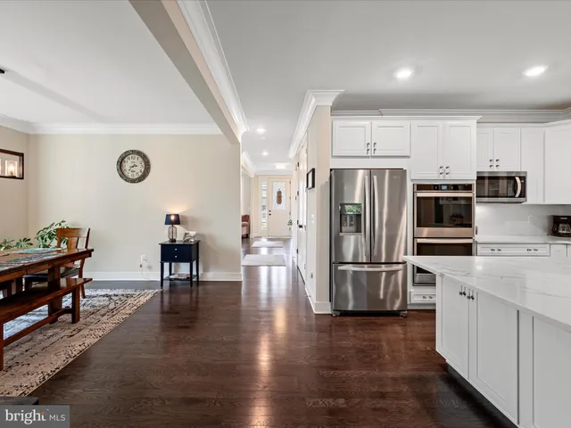 a kitchen with stainless steel appliances a refrigerator stove microwave and cabinets