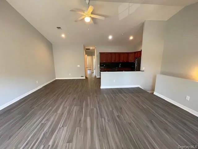 a view of kitchen and hall with wooden floor