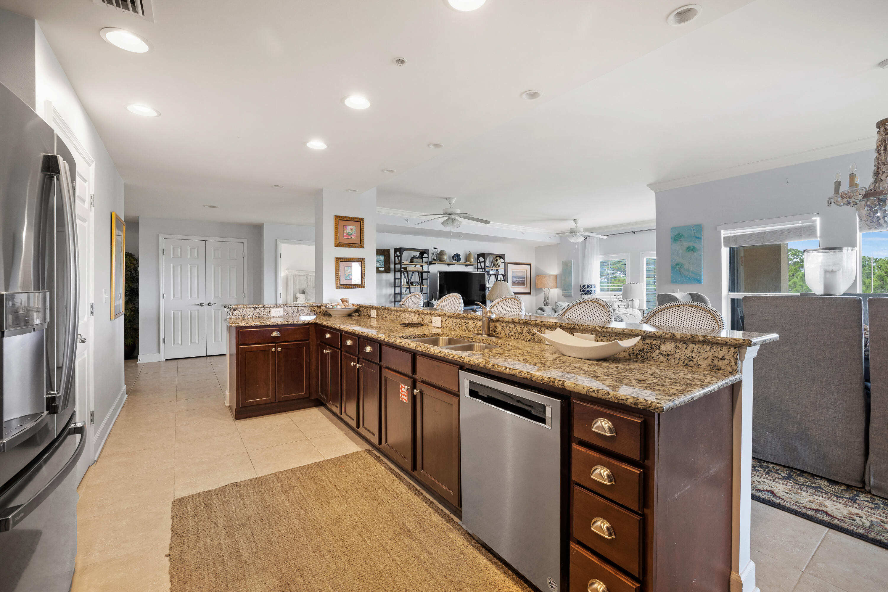1732 West County Highway 30A, Unit 403R Santa Rosa Beach, FL 32459 - Photo 11 of 57 a kitchen with stainless steel appliances granite countertop a stove top oven a sink dishwasher and a refrigerator with the cabinets