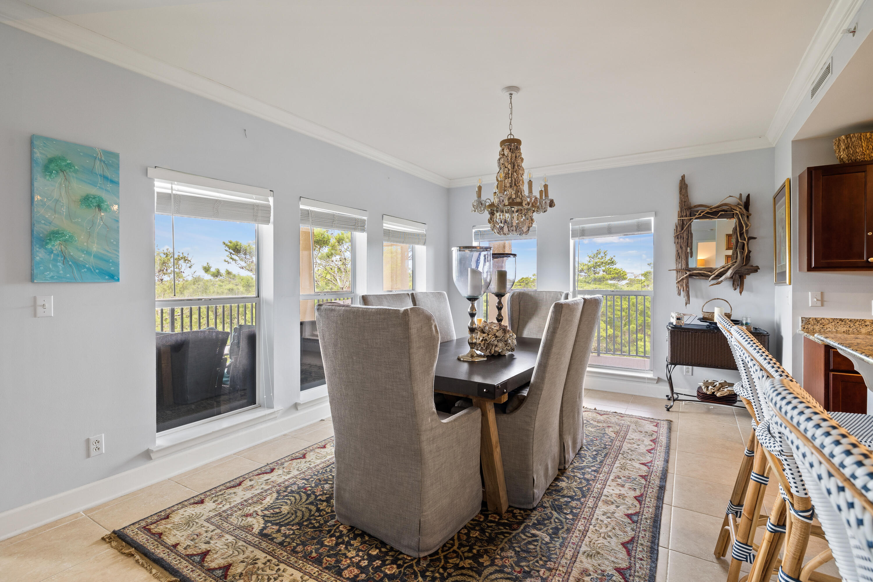 1732 West County Highway 30A, Unit 403R Santa Rosa Beach, FL 32459 - Photo 13 of 57 a dining room with furniture a rug a potted plant and a chandelier