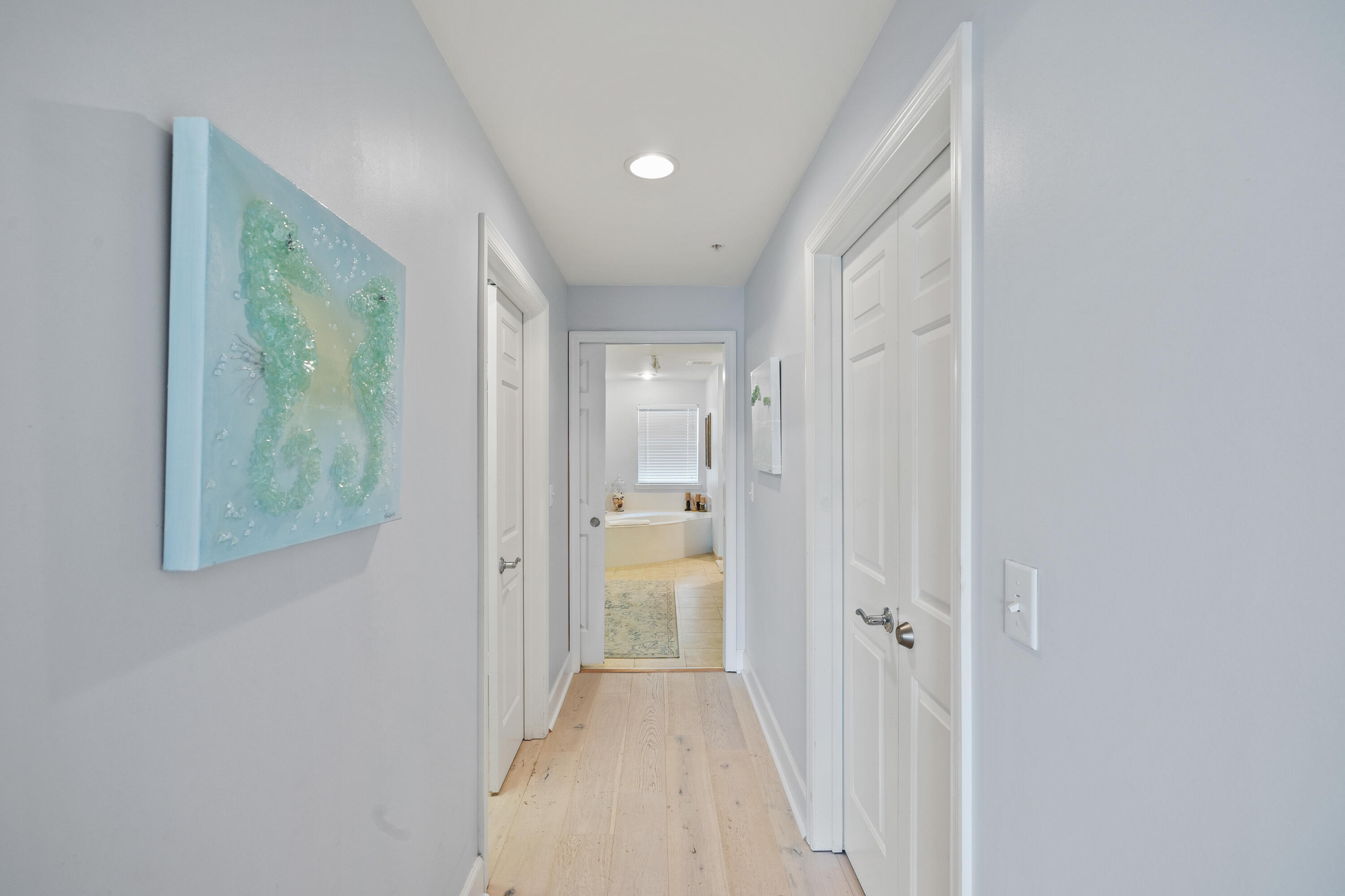 1732 West County Highway 30A, Unit 403R Santa Rosa Beach, FL 32459 - Photo 25 of 57 a view of a hallway with wooden floor and a bathroom