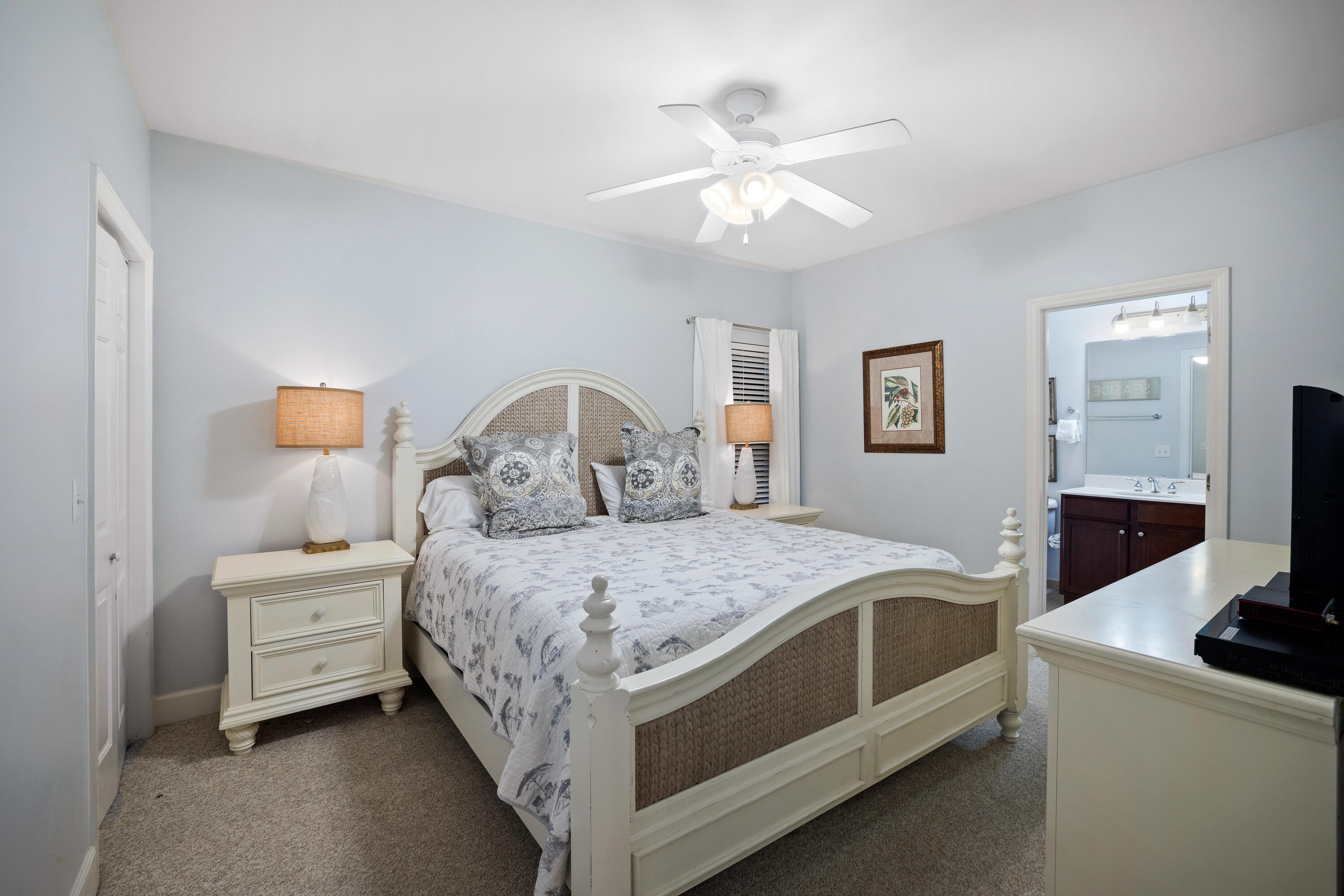 1732 West County Highway 30A, Unit 403R Santa Rosa Beach, FL 32459 - Photo 28 of 57 a bedroom with a bed and a chandelier