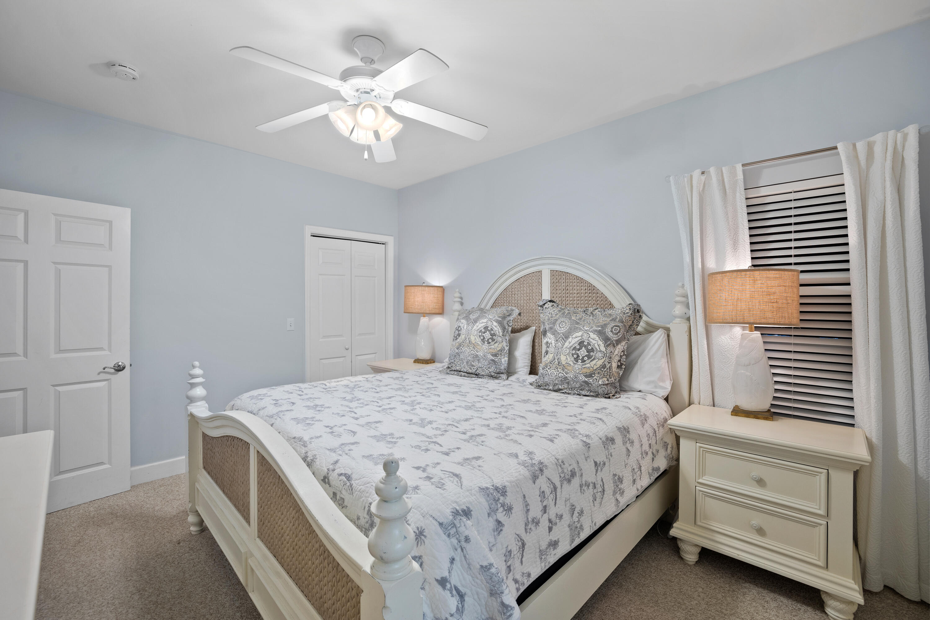 1732 West County Highway 30A, Unit 403R Santa Rosa Beach, FL 32459 - Photo 29 of 57 a bedroom with a bed and a chandelier