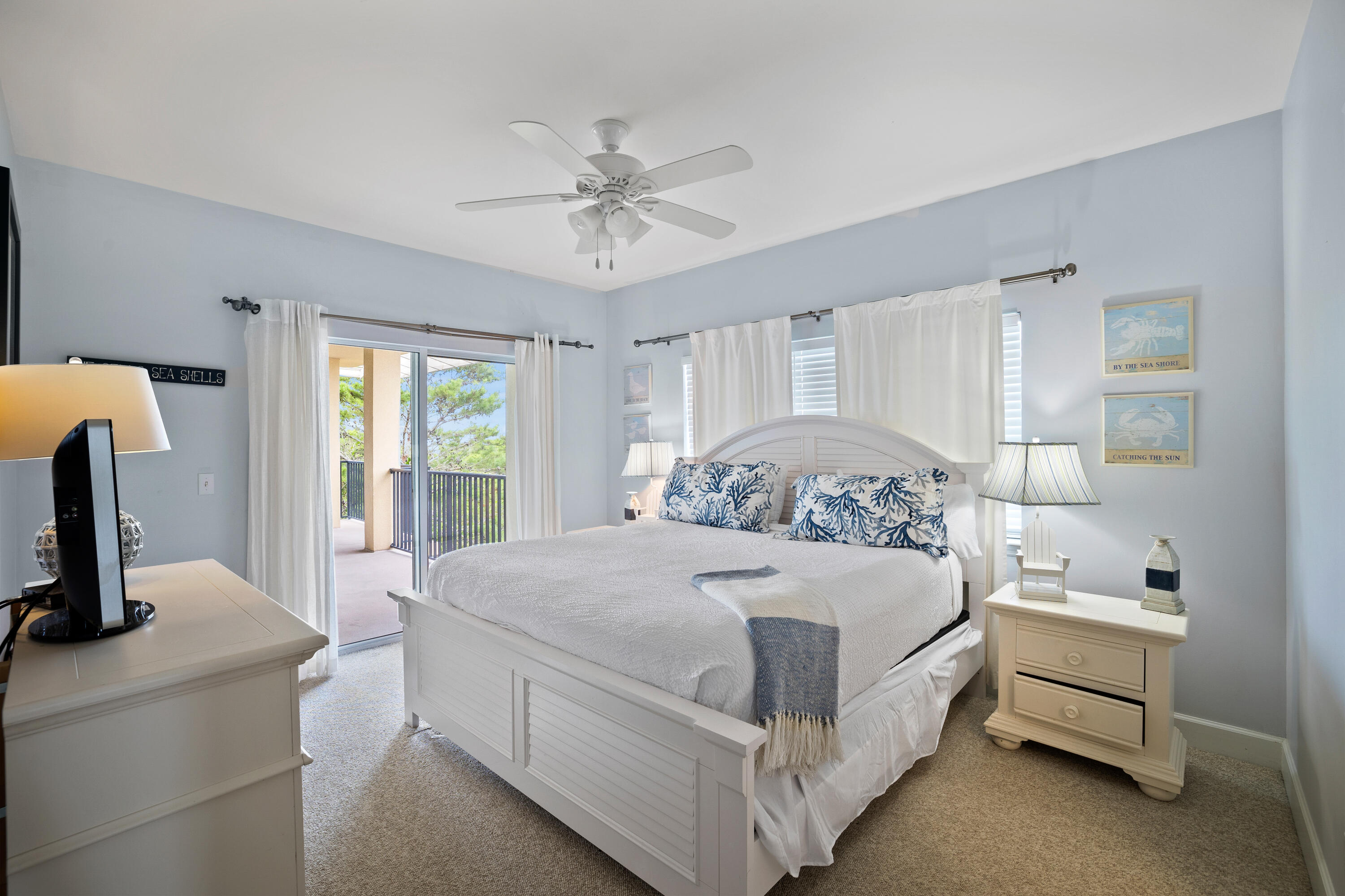 1732 West County Highway 30A, Unit 403R Santa Rosa Beach, FL 32459 - Photo 31 of 57 a bedroom with a bed and a chandelier