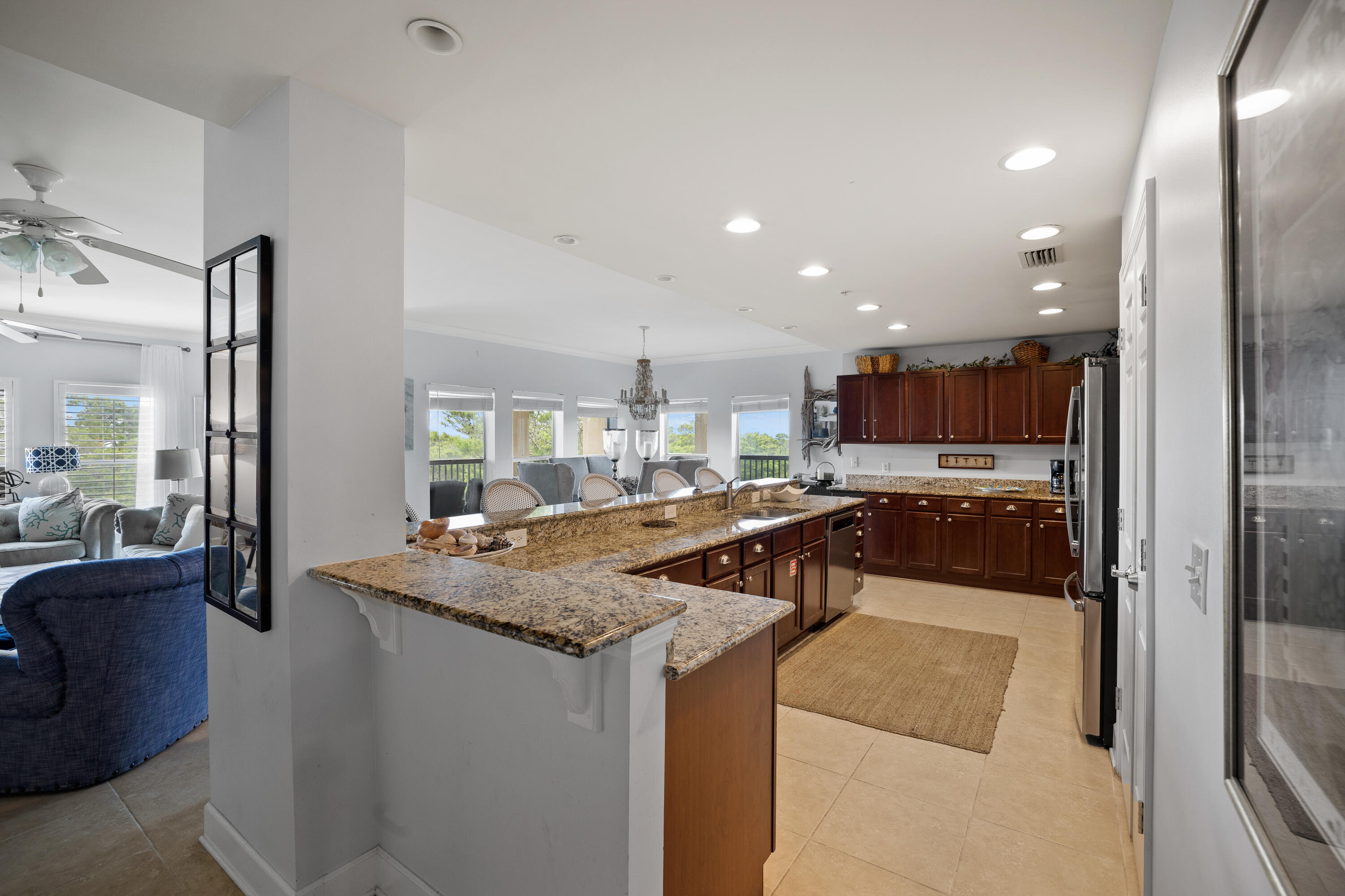 1732 West County Highway 30A, Unit 403R Santa Rosa Beach, FL 32459 - Photo 9 of 57 a kitchen with stainless steel appliances granite countertop a sink and a refrigerator