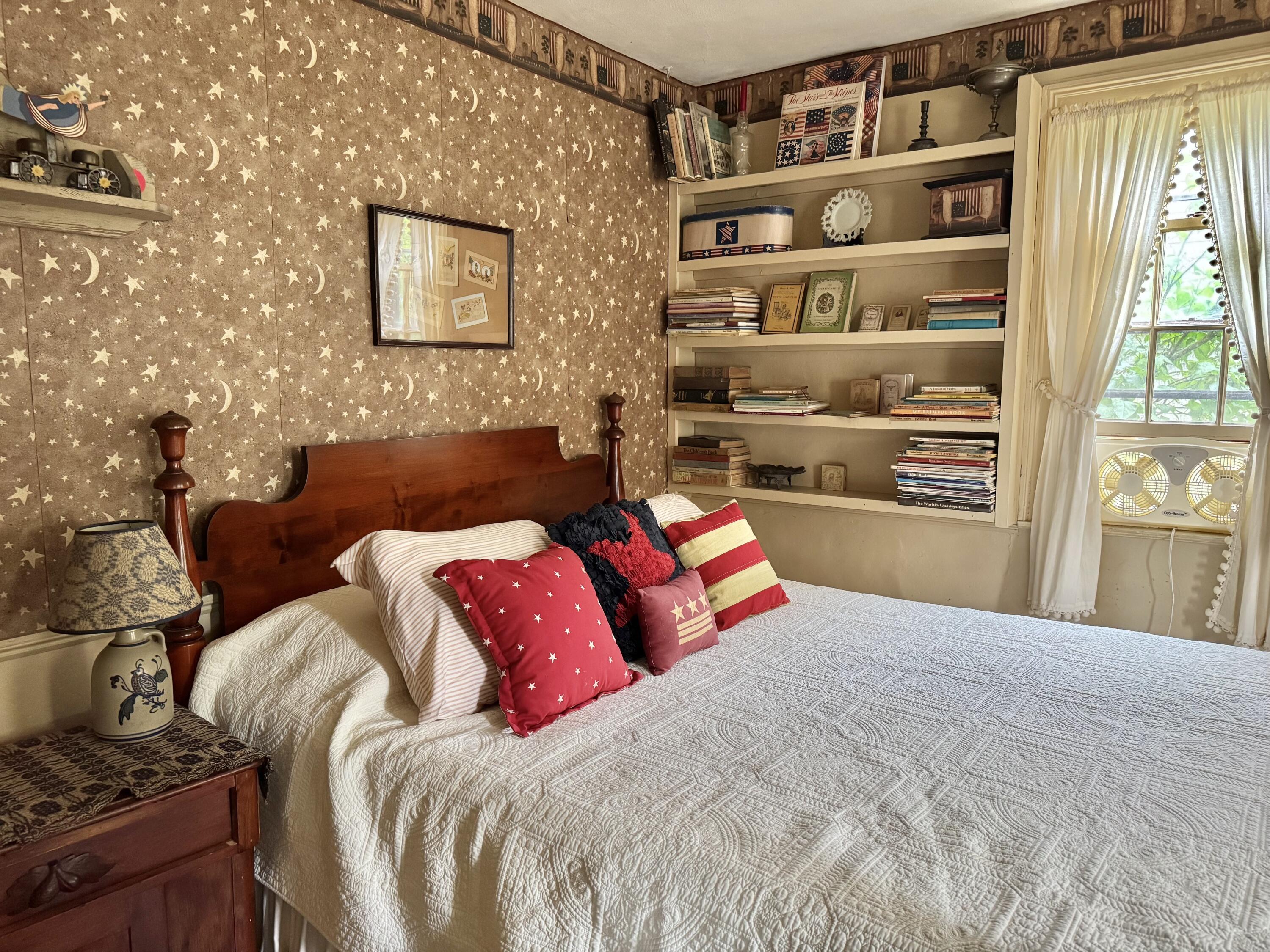 1580 Main Street Brewster, MA 02631 - Photo 13 of 20 a bed sitting in a bedroom next to a window