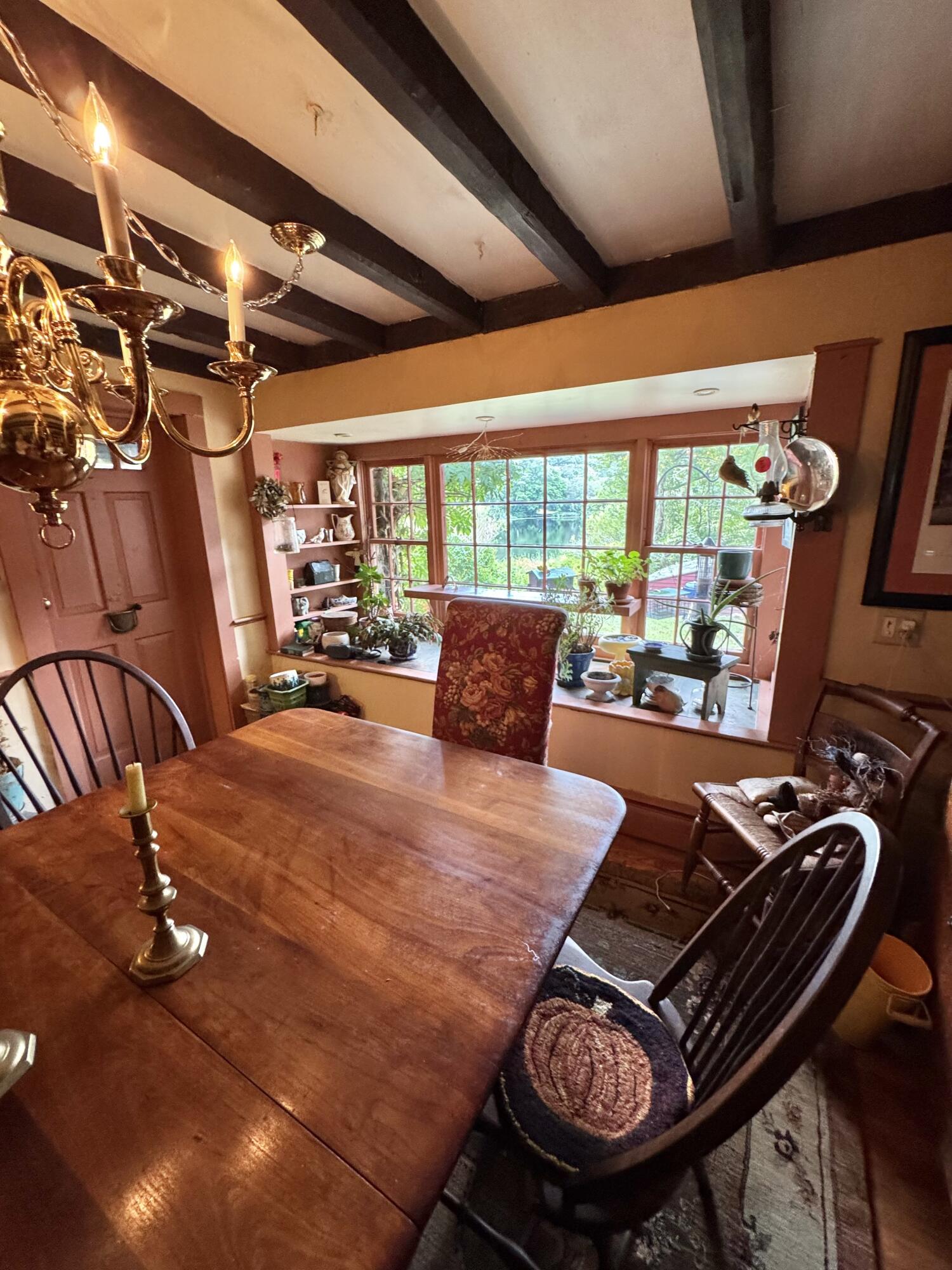 1580 Main Street Brewster, MA 02631 - Photo 4 of 20 a bed sitting in a room next to a window