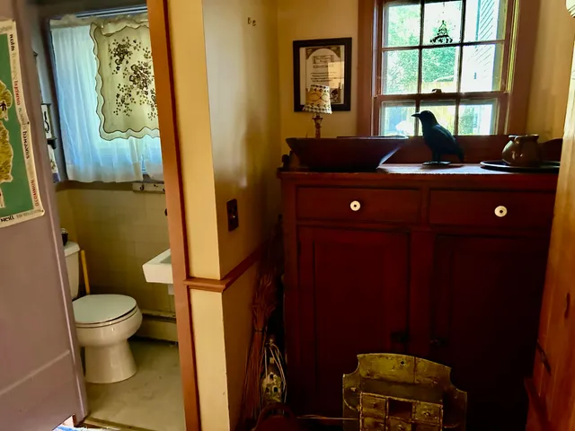 a bathroom with a sink toilet and window