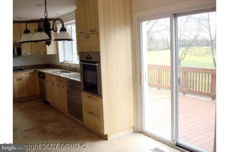 304 Old Courthouse Road Northeast Vienna, VA 22180 - Photo 13 of 20 a kitchen with stainless steel appliances granite countertop a stove a sink and a refrigerator