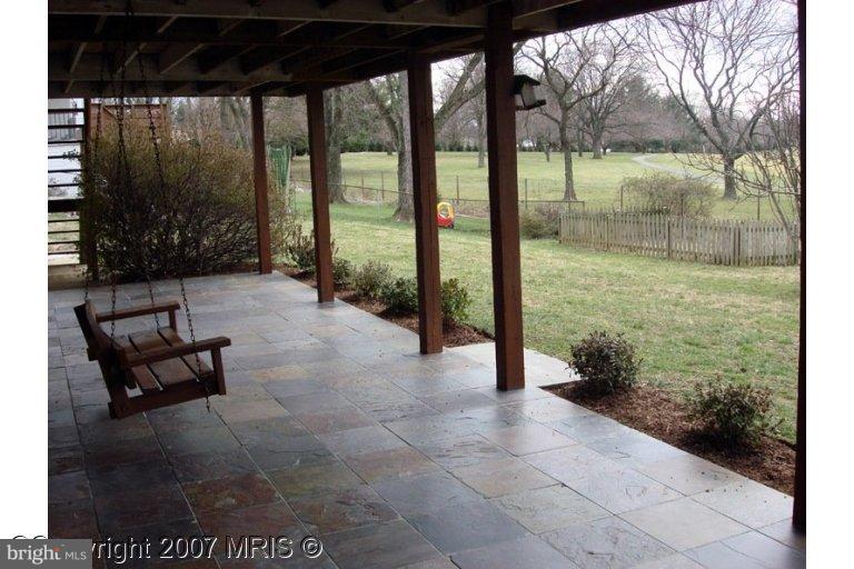 304 Old Courthouse Road Northeast Vienna, VA 22180 - Photo 4 of 20 a view of a porch with chairs and backyard