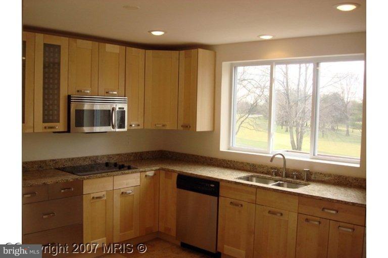 304 Old Courthouse Road Northeast Vienna, VA 22180 - Photo 7 of 20 a kitchen with granite countertop a sink and a window