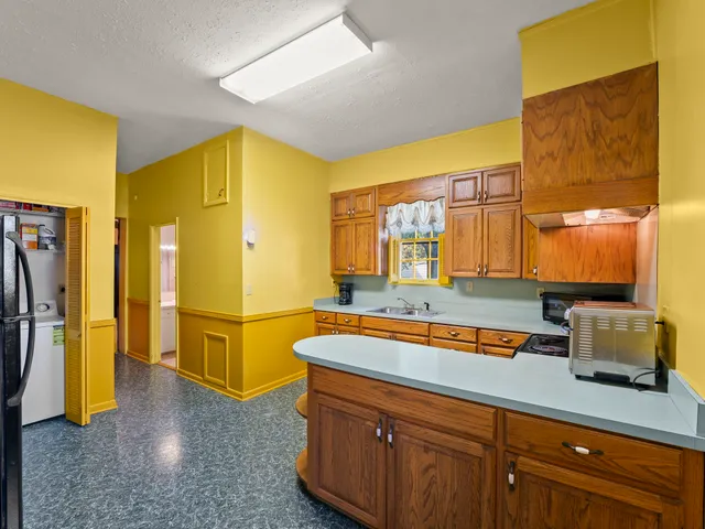 a kitchen with stainless steel appliances a stove a sink and cabinets