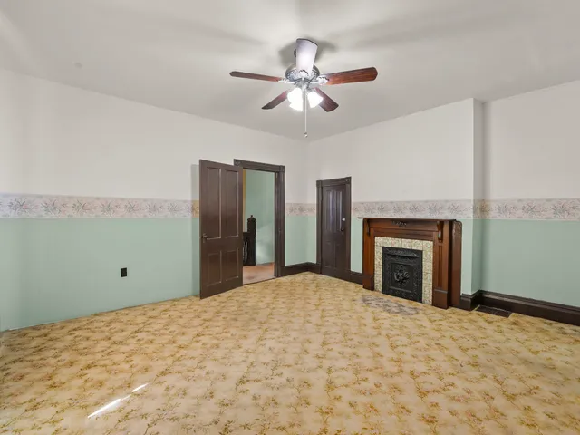 wooden floor fireplace and chandelier in a room