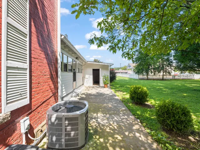 a view of living room with furniture and a fireplace