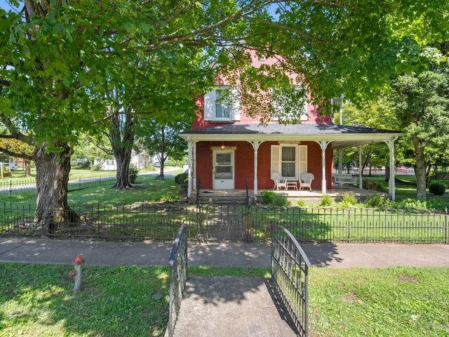 a view of a house with yard and tree s