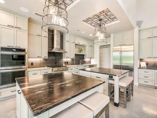 a kitchen with stainless steel appliances granite countertop a sink stove and cabinets
