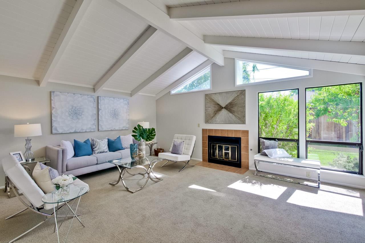 1875 Appletree Lane Mountain View, CA 94040 - Photo 12 of 39 a living room with furniture a fireplace and a floor to ceiling window