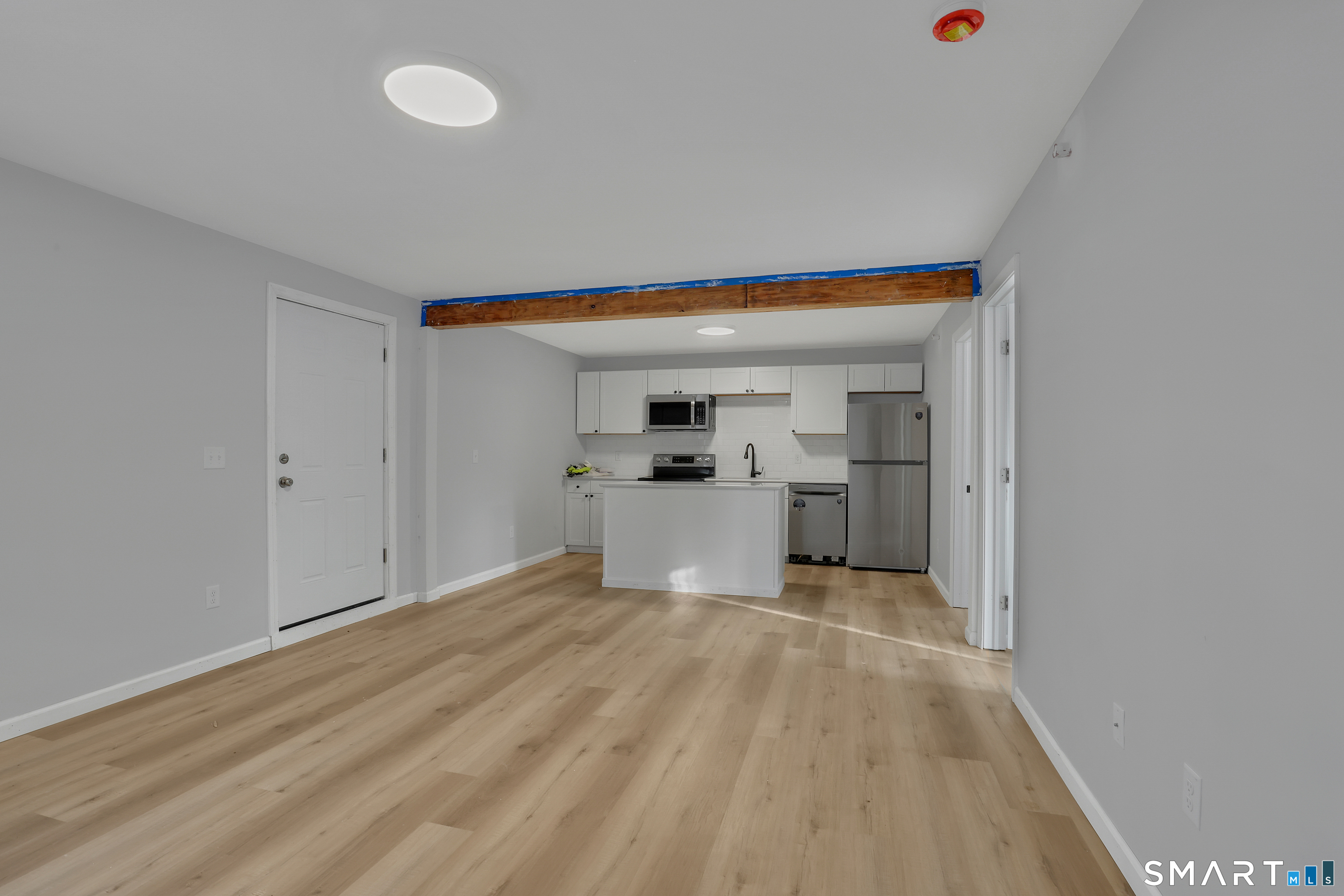a view of a kitchen with a sink and cabinets