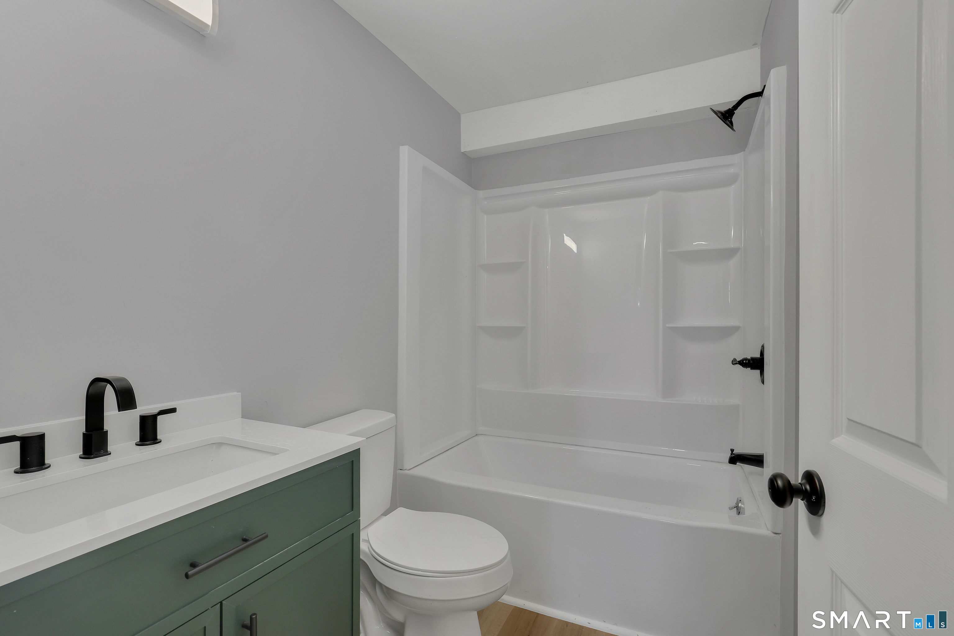 194 Hartford Road, Unit A Manchester, CT 06040 - Photo 13 of 14 a bathroom with a bathtub shower sink vanity mirror and toilet