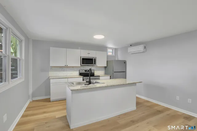 a kitchen with stainless steel appliances a sink stove and microwave