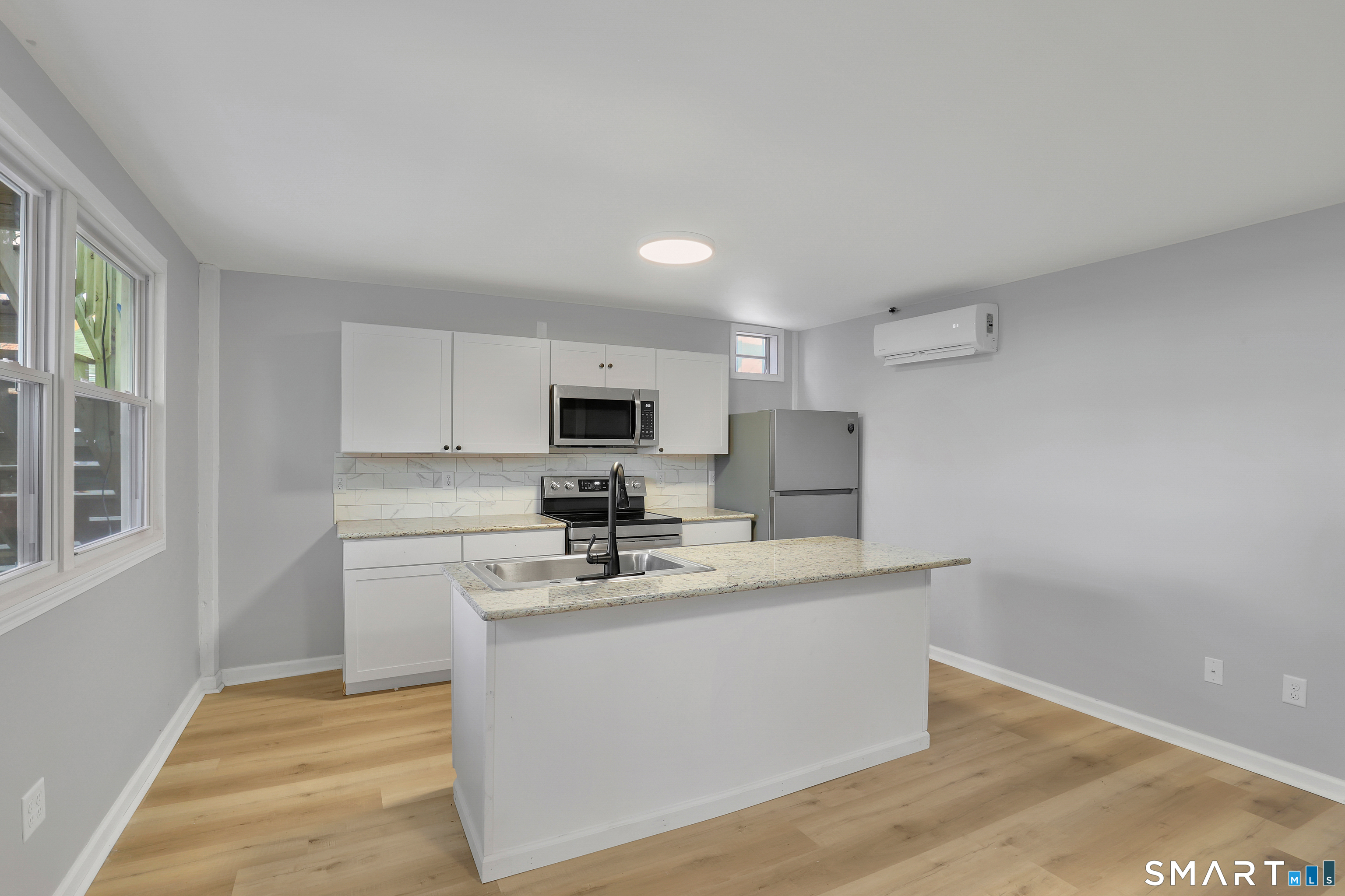 194 Hartford Road, Unit A Manchester, CT 06040 - Photo 3 of 14 a kitchen with stainless steel appliances a sink stove and microwave