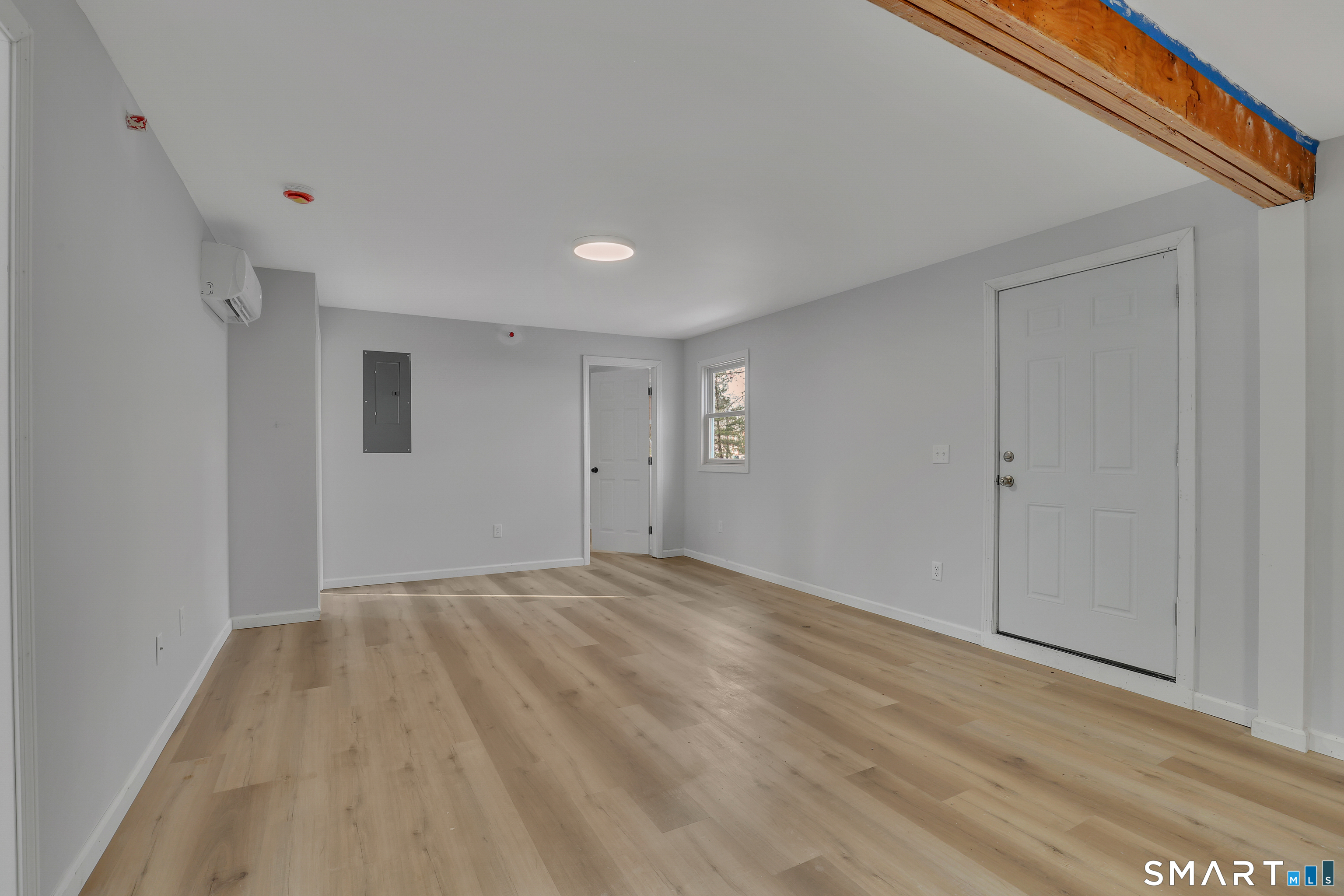 194 Hartford Road, Unit A Manchester, CT 06040 - Photo 5 of 14 a view of an empty room with wooden floor