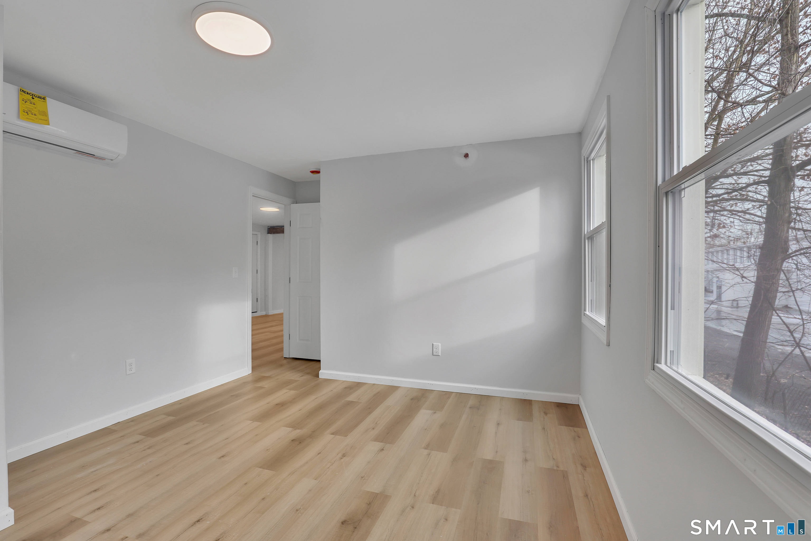 194 Hartford Road, Unit A Manchester, CT 06040 - Photo 9 of 14 a view of empty room with wooden floor and fan