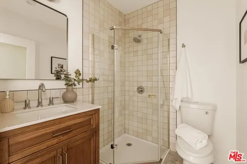 a bedroom with a bed couch and window