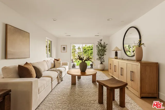 a living room with furniture a fireplace and a potted plant
