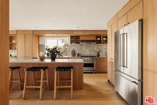 a kitchen with stainless steel appliances a sink and a refrigerator