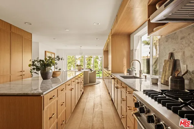 a kitchen with sink stove and cabinets
