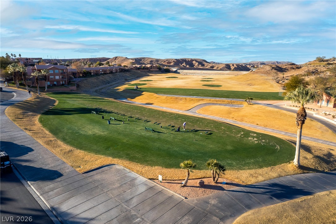 1460 Blue Ridge Trail Mesquite, NV 89027 - Photo 36 of 39 An aerial perspective reveals a vibrant golf course nestled against a backdrop of rugged hills and residential structures.