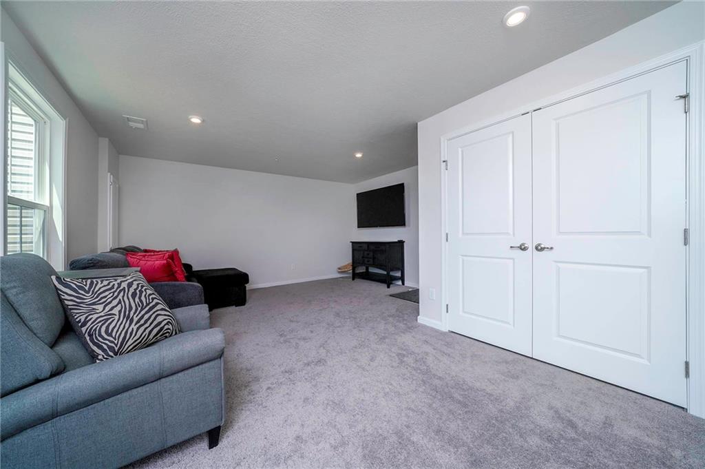 157 Cole Drive McKees Rocks, PA 15136 - Photo 13 of 25 Lower level family room is larger than it looks! TV mount stays here. Garage access and patio doors to backyard.