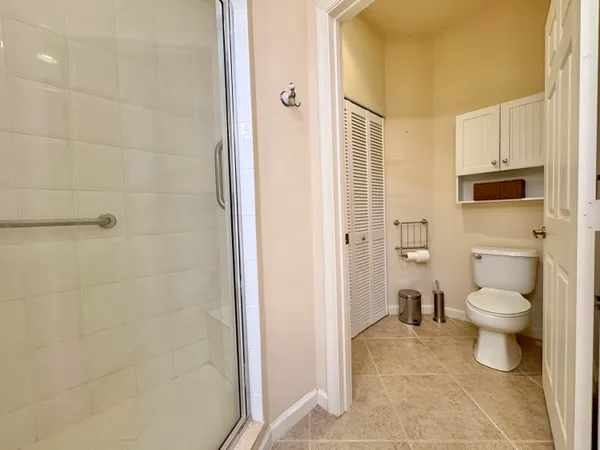 a bathroom with a toilet and a shower