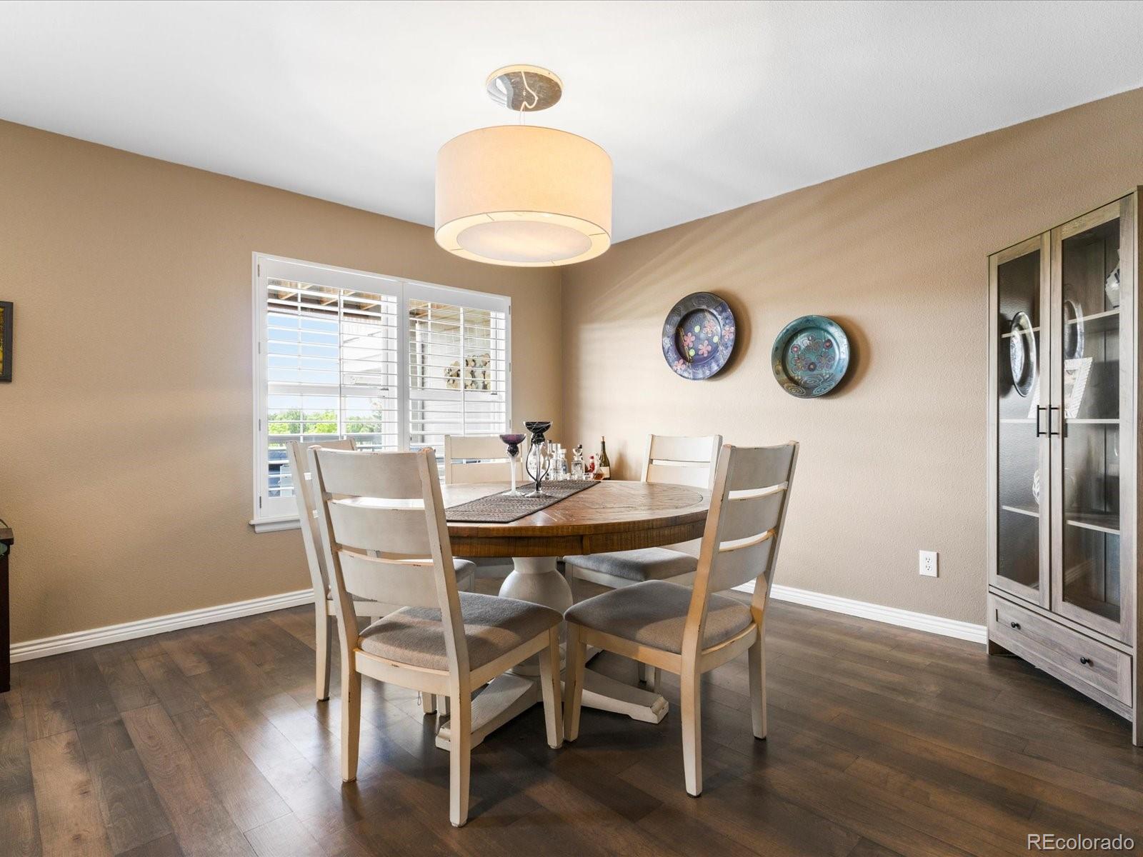 9323 Notts Court Lone Tree, CO 80124 - Photo 12 of 45 a view of a dining room with furniture and wooden floor