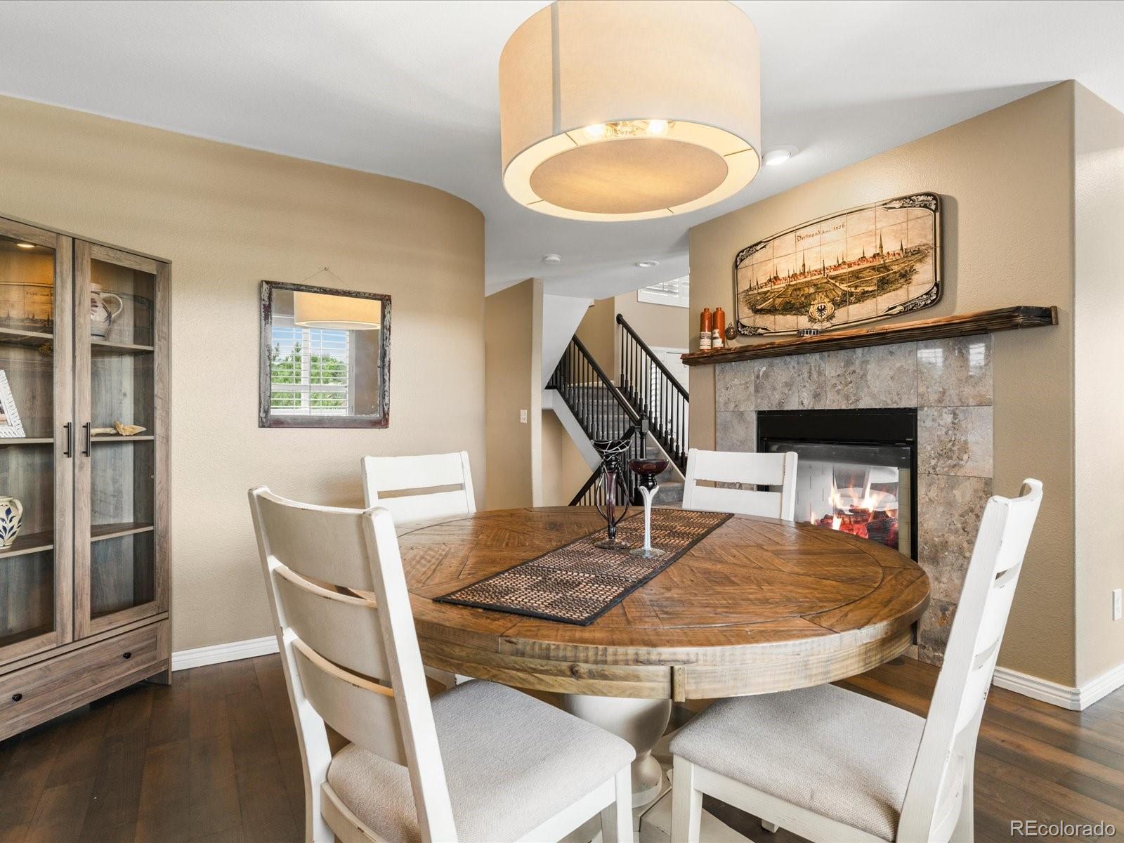9323 Notts Court Lone Tree, CO 80124 - Photo 13 of 45 a dining room with furniture a rug and a chandelier